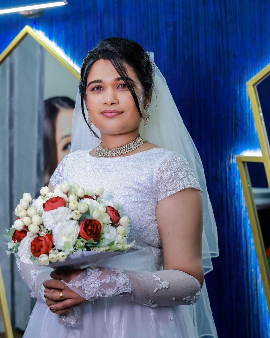 Bride in a white gown and veil holding a bouquet
