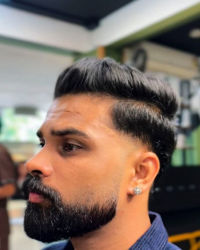 Side profile of a men’s skin fade with a sculpted beard