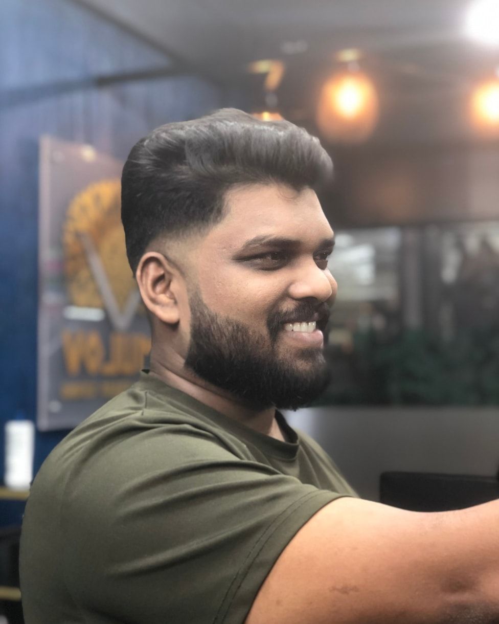 Men’s fade haircut with a groomed beard