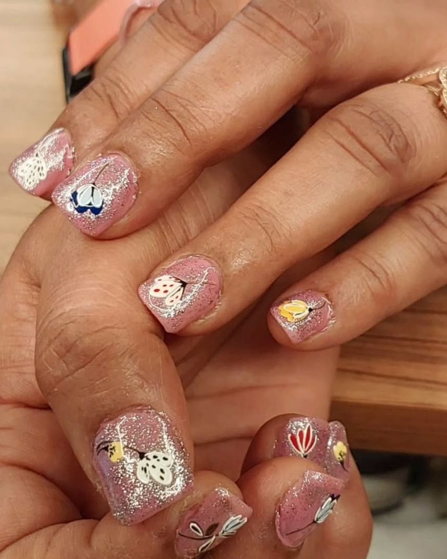 Glitter gel nails with hand-painted floral nail art
