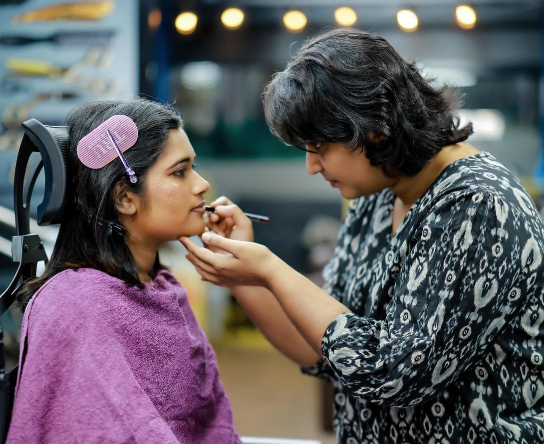 Makeup artist applying lip colour to a bride
