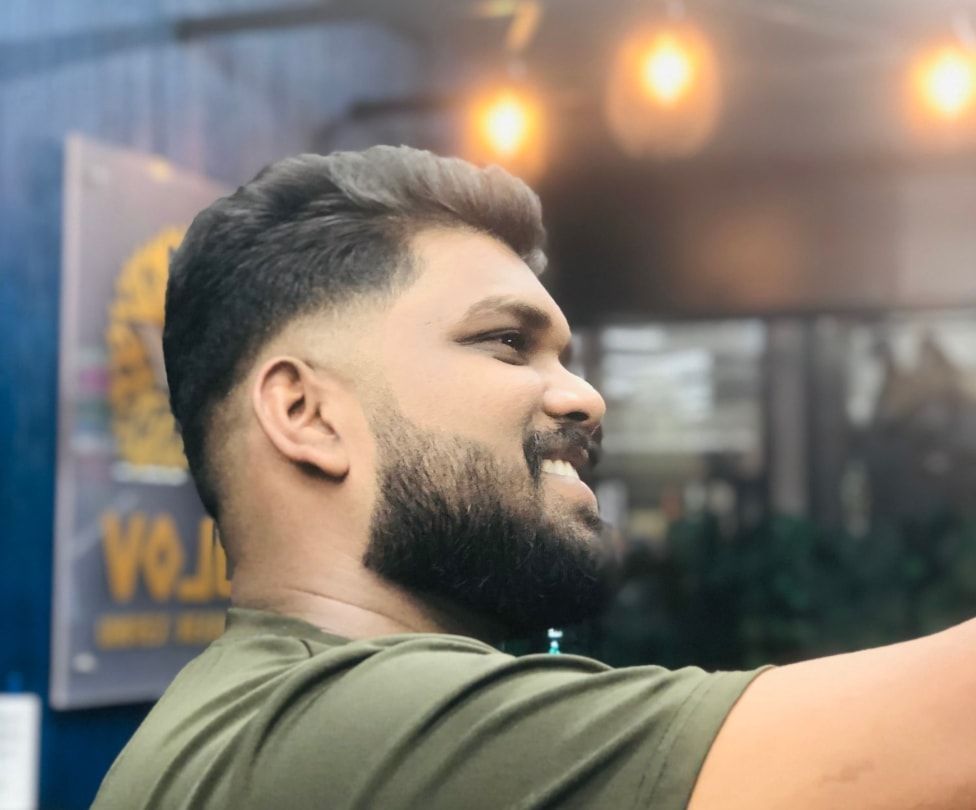 Man with a fresh fade haircut and shaped beard at Volume