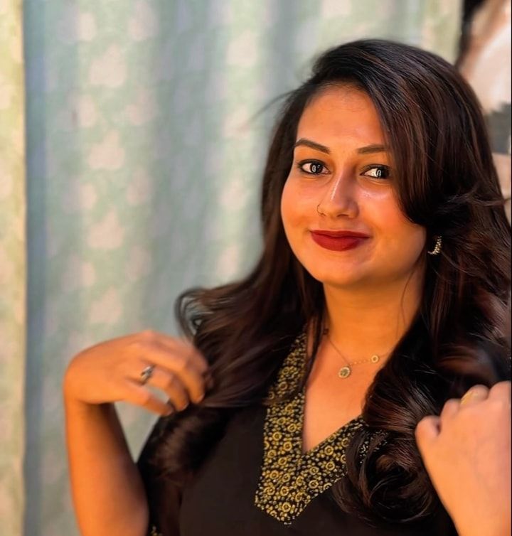 Client with glossy, softly curled hair after a treatment